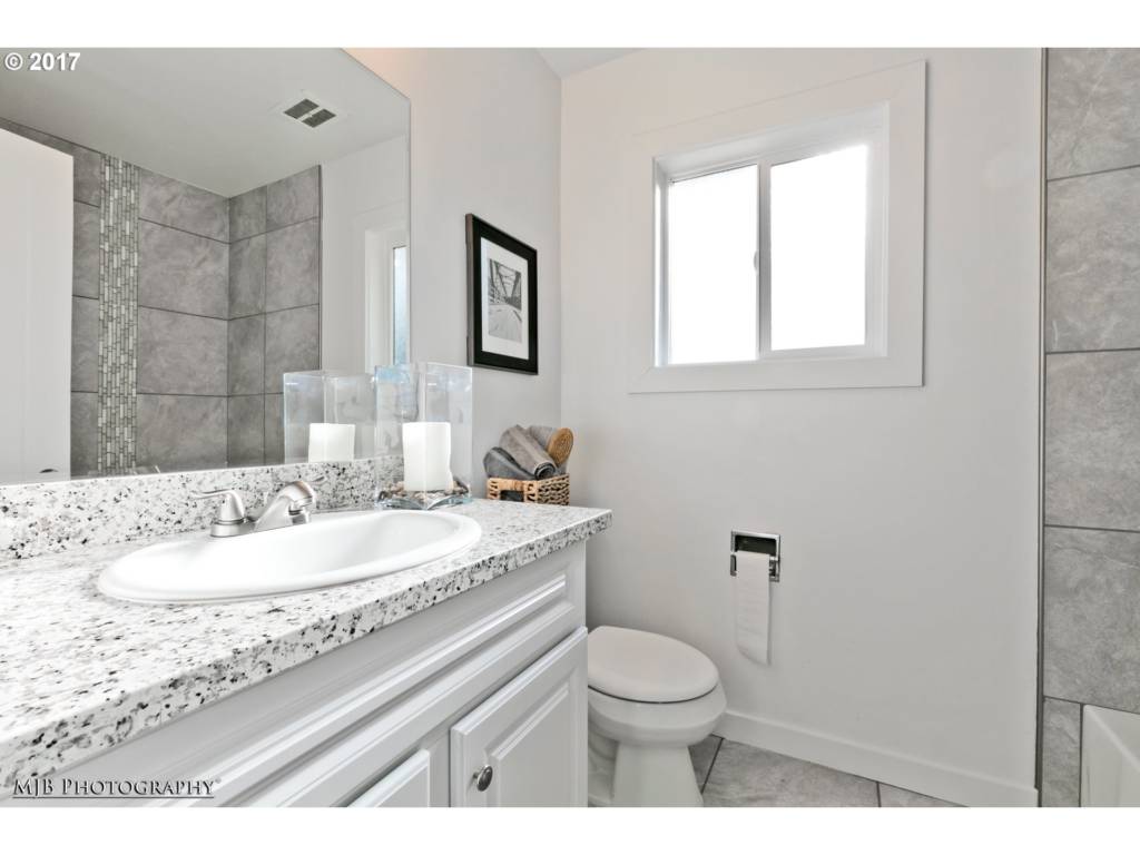 renovated bathroom with new tile and white paint