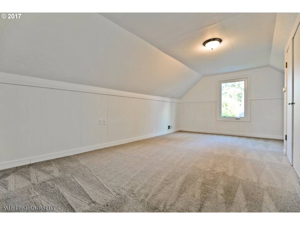 large bedroom upstairs with new carpet and paint