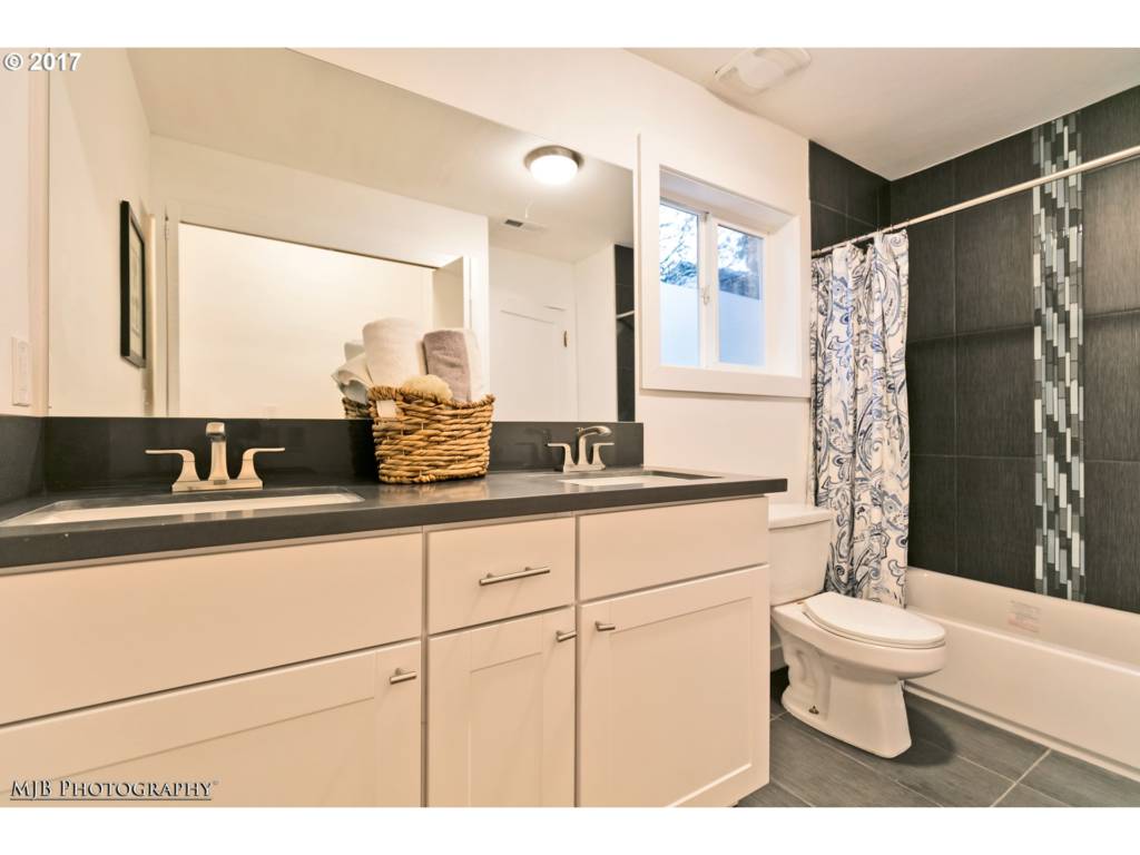 renovated bathroom with double vanity 